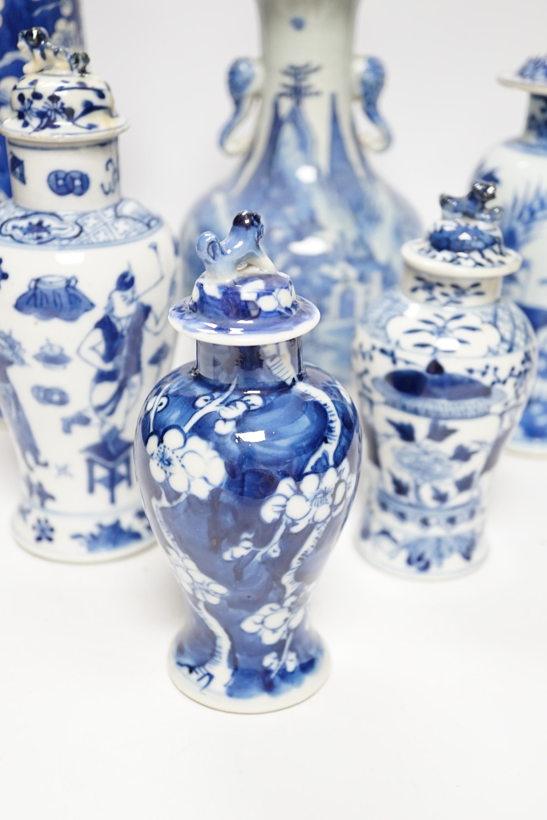 A late 19th century Chinese blue and white twin elephant head handle vase and five other 19th century Chinese blue and white vases, tallest 26cm